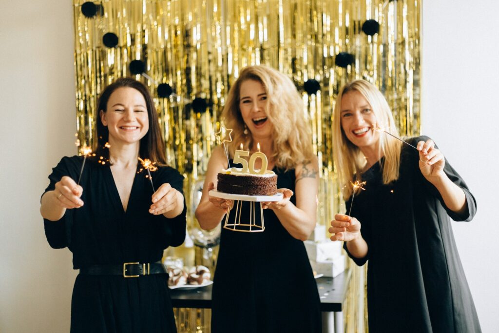 2 Women Holding Cake Smiling
